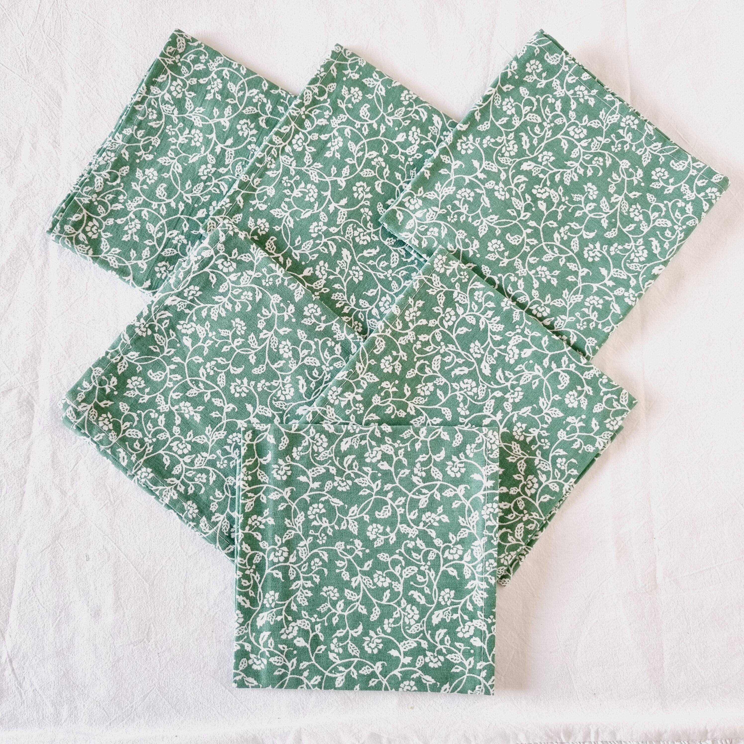 6 green cotton cloth napkins with white linens