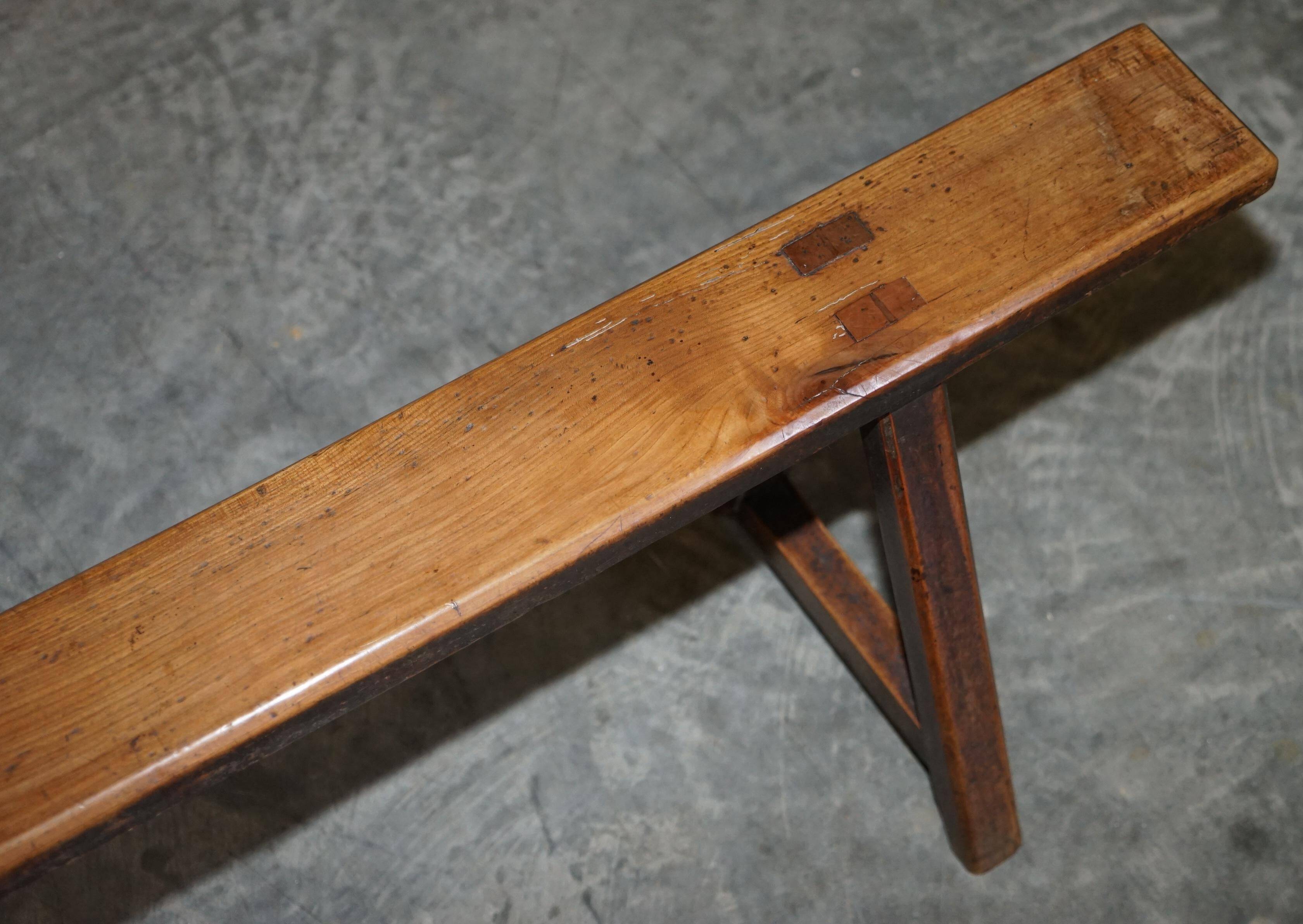 Pair of antique Victorian trestle benches in fruitwood.