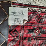 Oriental carpet knotted with red hand