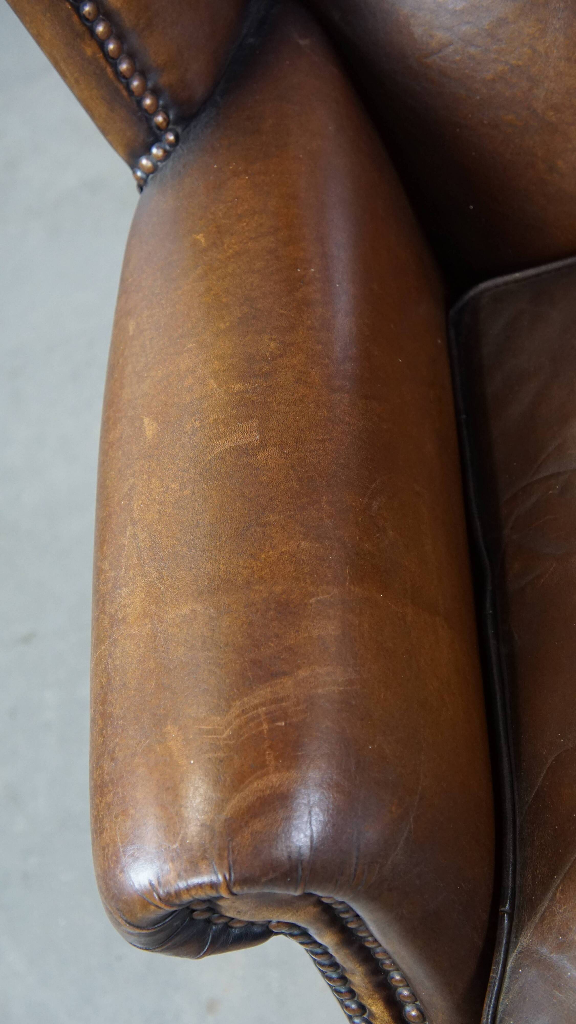 Fauteuil en cuir de mouton avec finition clous décoratifs