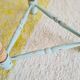Antique tripod stool with striped seat.