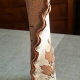 Small clay vase decorated with leaves