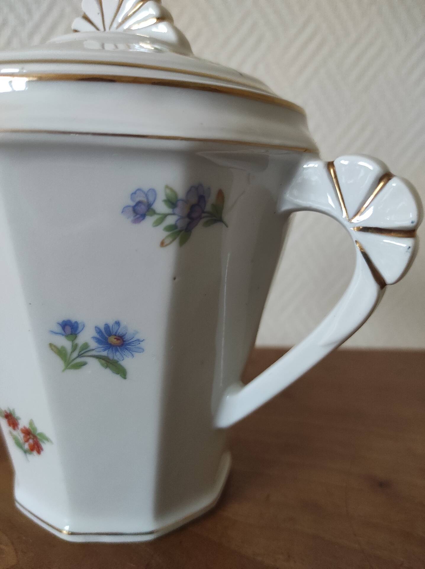 Antique porcelain sugar bowl with a decagonal base.