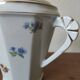 Antique porcelain sugar bowl with a decagonal base.