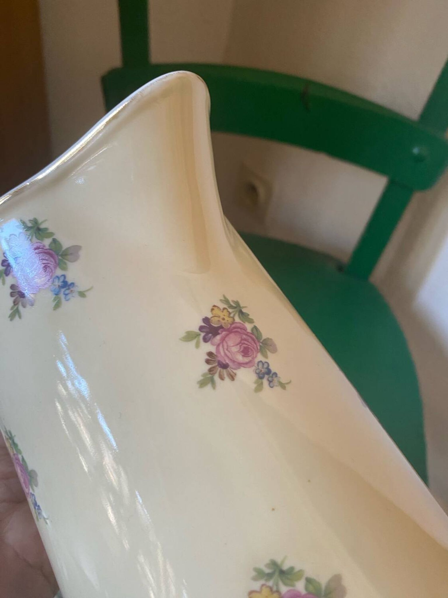 Old flowery and gilded pitcher.