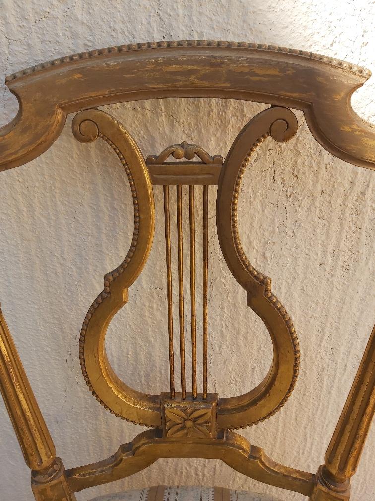 Pair of chairs with a golden lyre