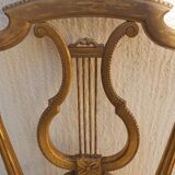 Pair of chairs with a golden lyre