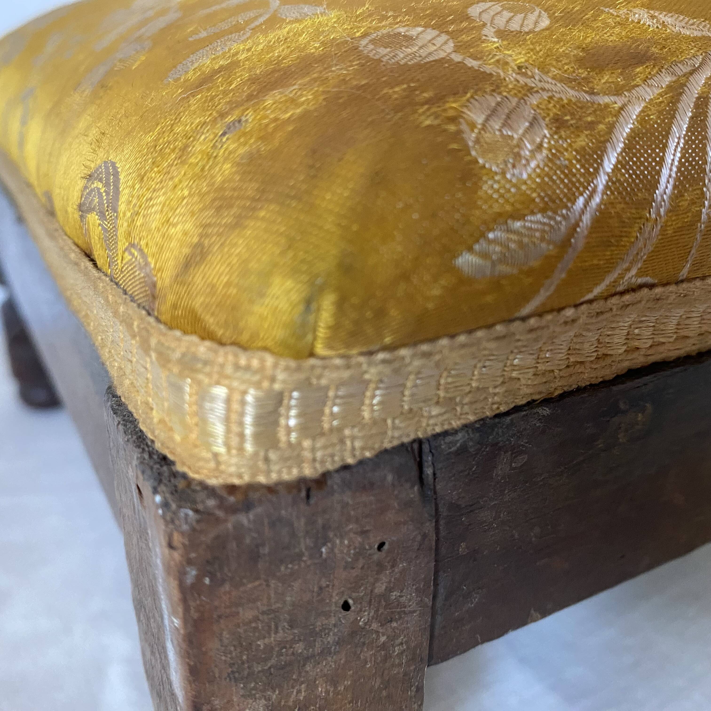 Low stool with antique wood and fabric footrest