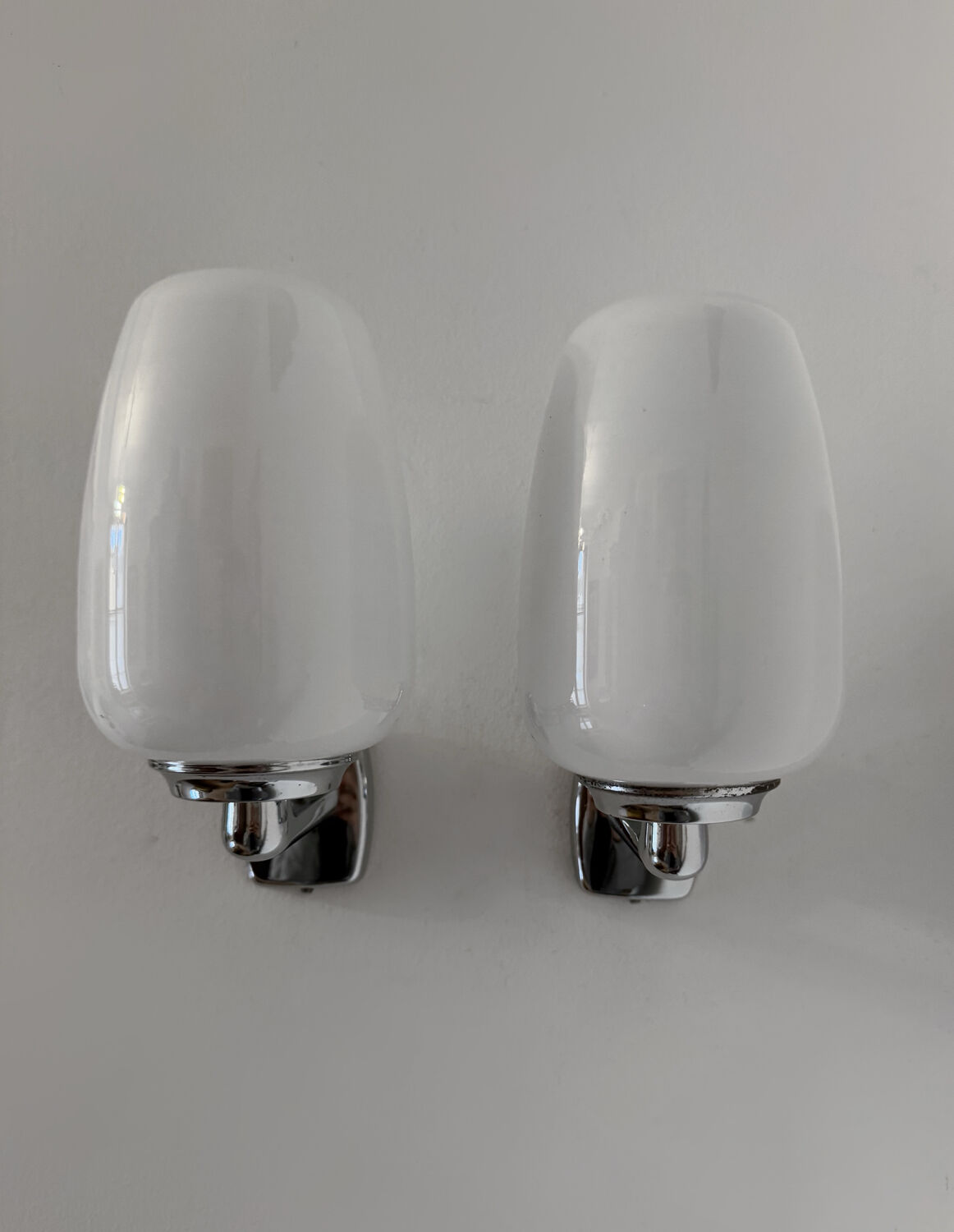 Chrome and opaline wall lights from the 70s.