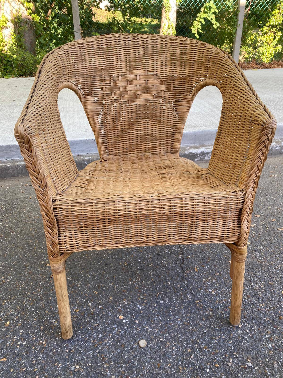 Rattan and woven wicker armchair in vintage bohemian style
