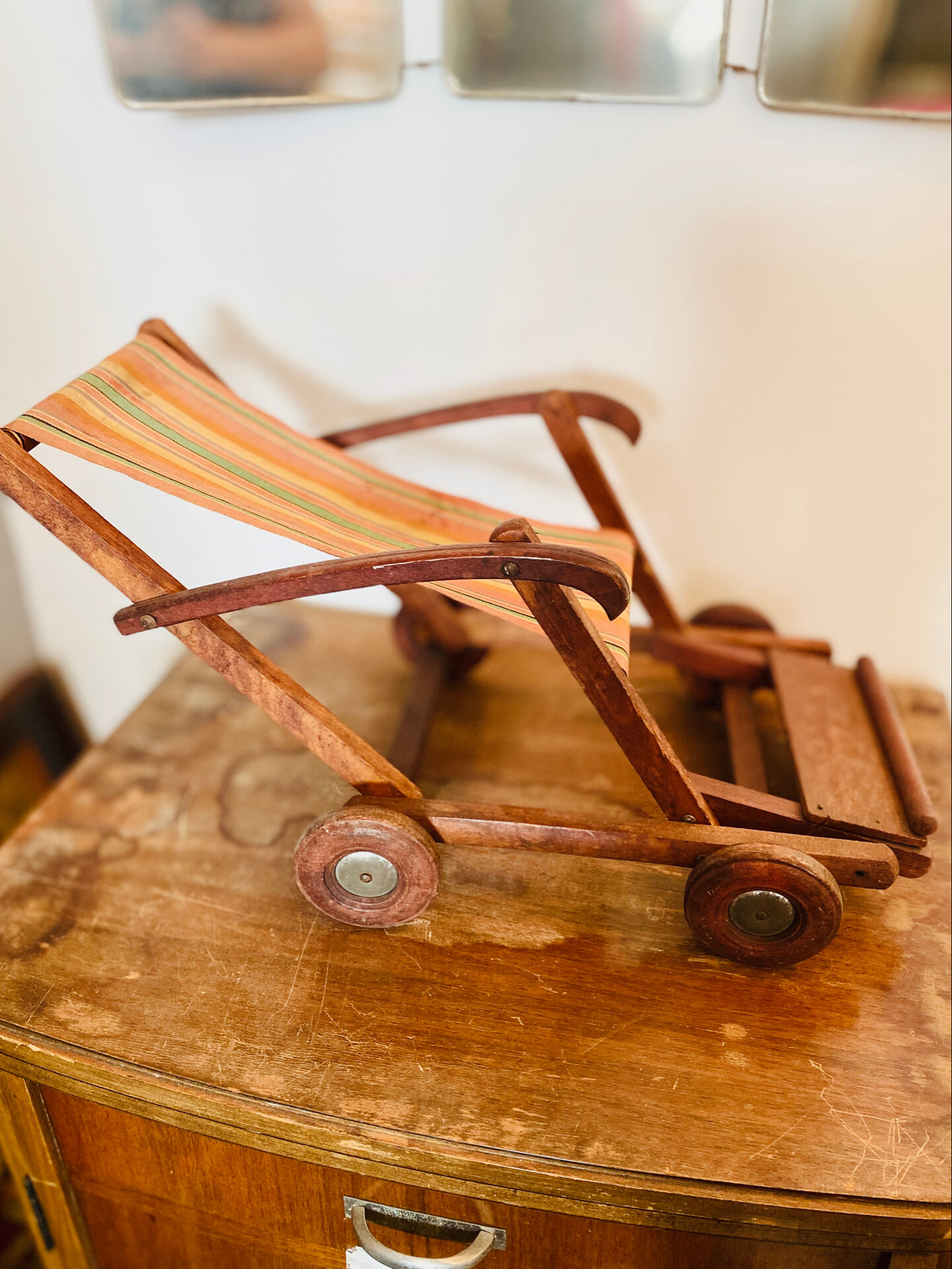 Vintage wooden folding doll's deckchair on wheels