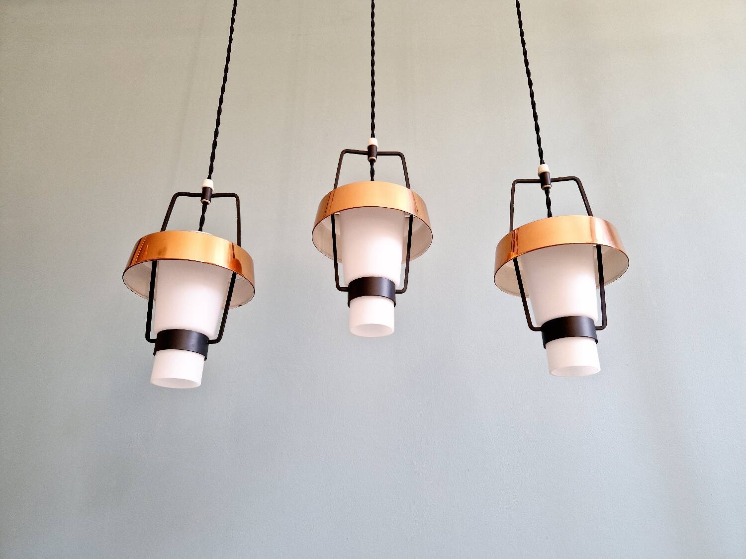 Trio of Scandinavian pendant lights in opaline and copper metal, 1960s