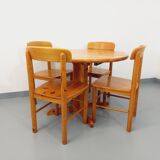 Suite of a round table with extension and 4 vintage pine chairs from the 60s and 70s