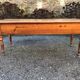 Antique cherry farmhouse table with turned legs and 2 drawers.