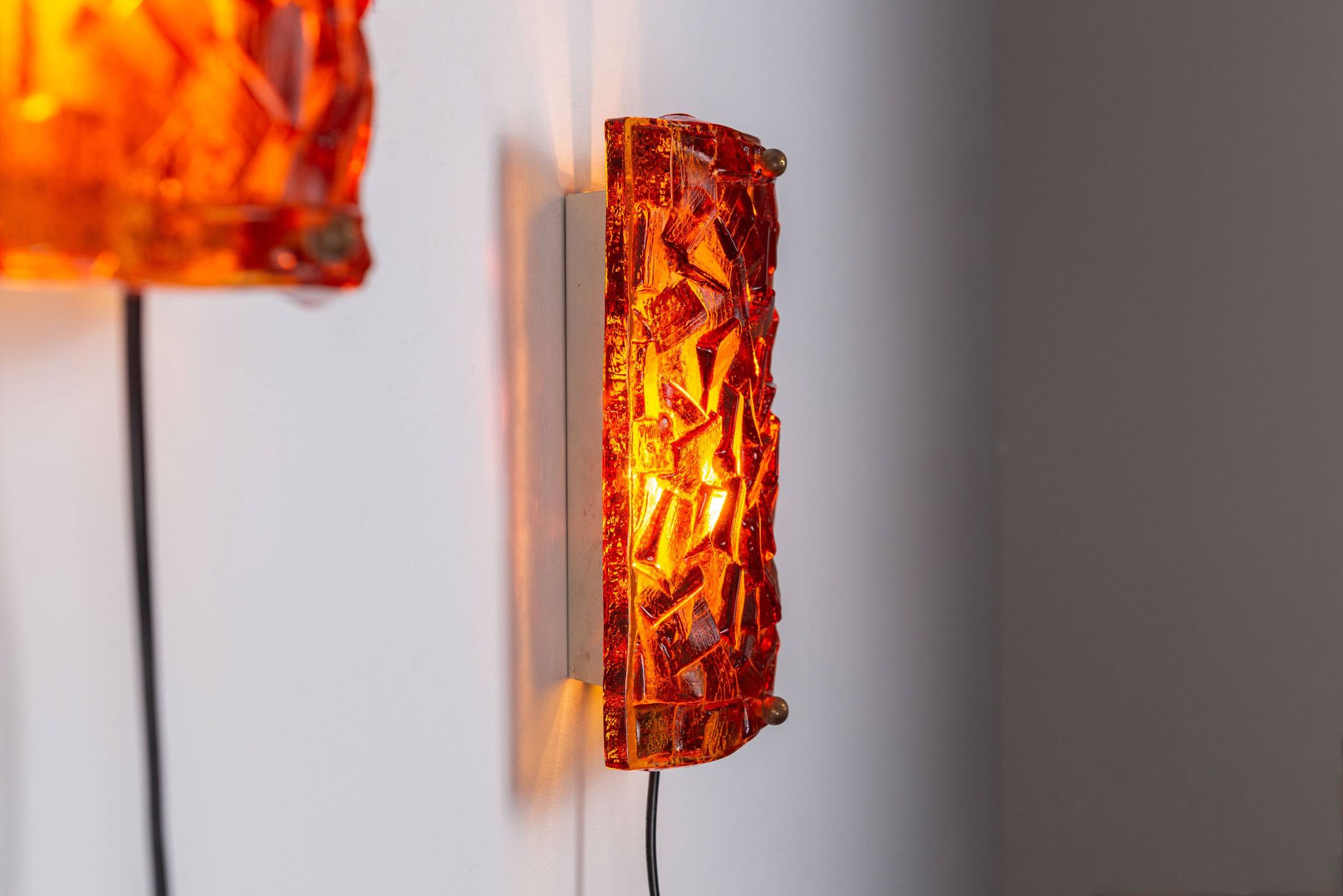 Vitrika Nybro amber coloured wall lamps