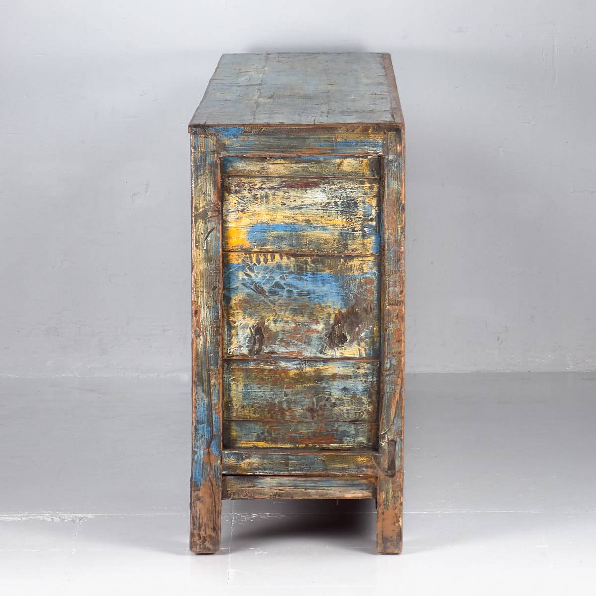 Old wooden entrance buffet in blue and yellow tones (circa 1920).