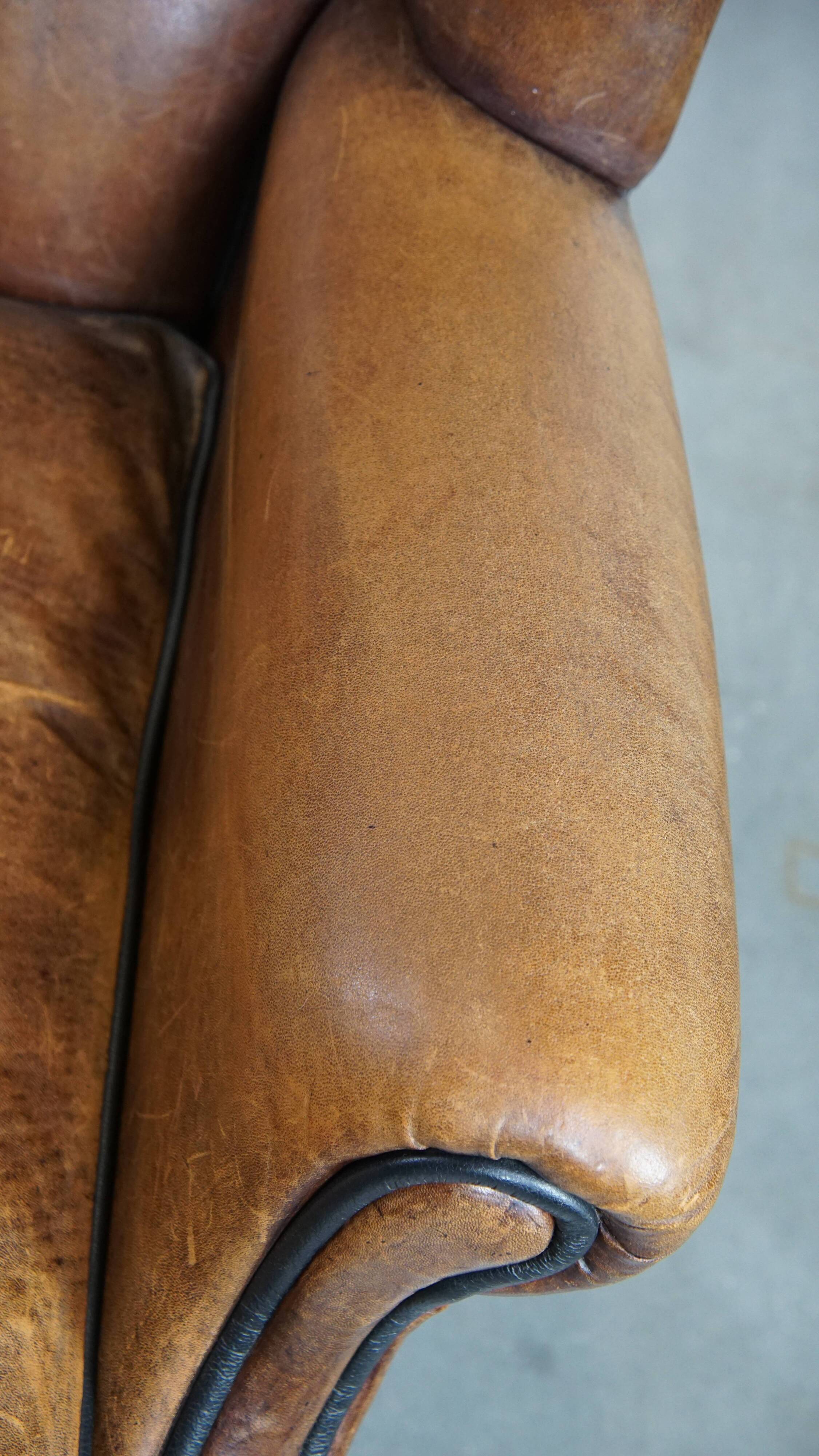 Sheep leather wingback chair finished with black piping