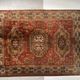 Antique wool rugs with designs on a red background, 20th century.
