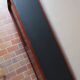 Teak enfilade, sliding doors, black faux leather top, 1970s.