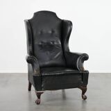 Antique black English cow leather wingback armchair from the 19th century