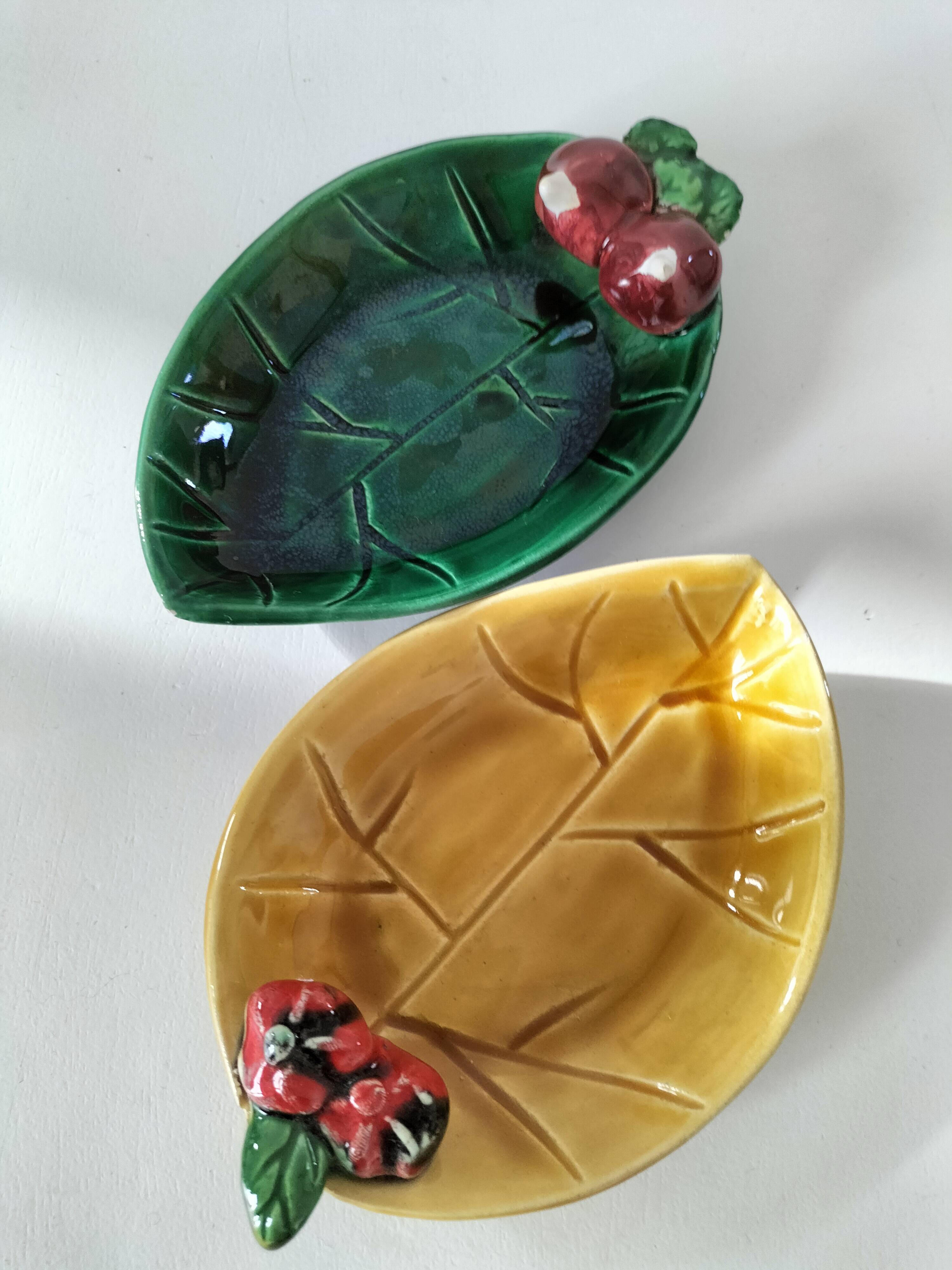 Two relief bowls with leaf designs, radishes, and tomatoes.