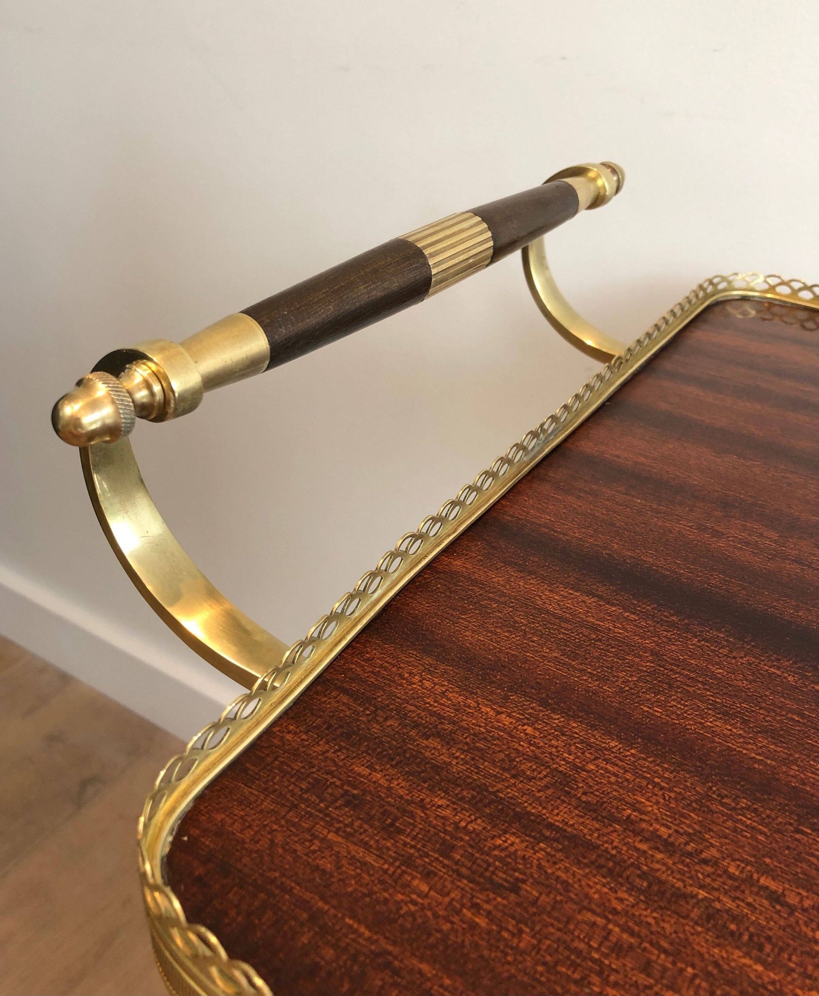 Mahogany and brass rolling table in the style of Maison Jansen.
