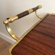 Mahogany and brass rolling table in the style of Maison Jansen.