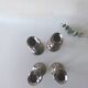 Four twisted silver candlesticks