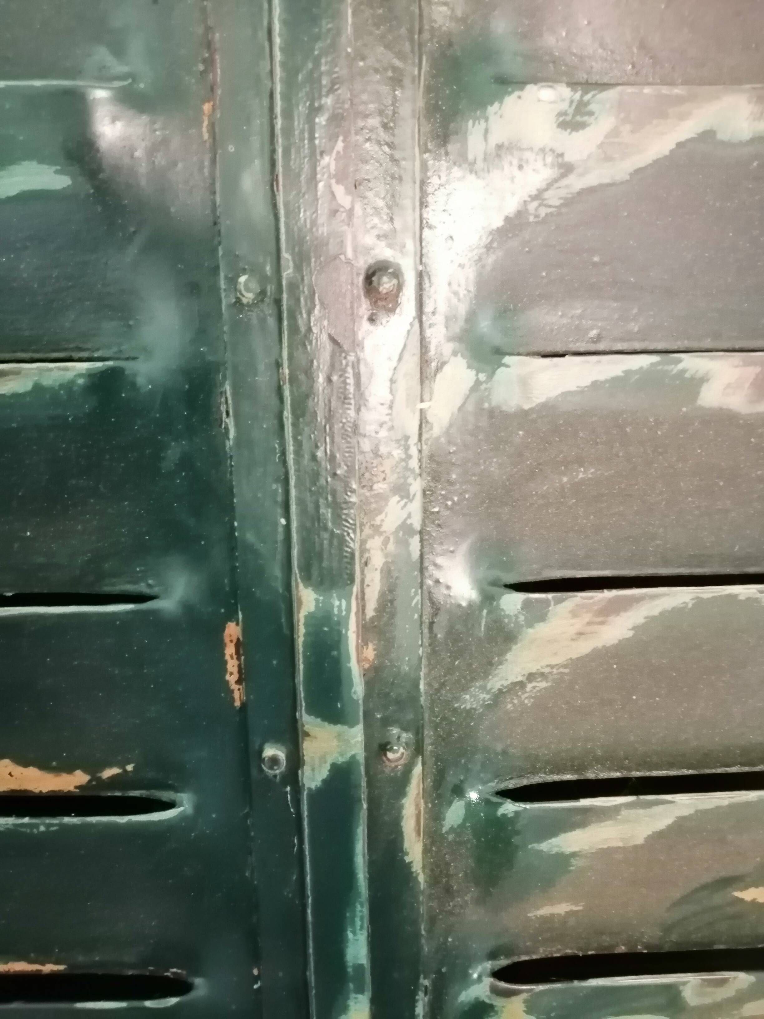 Lot of old green shutters in 4-part iron screen headboard