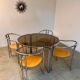 Table ronde vintage tubulaire en métal et verre fumé design année 70