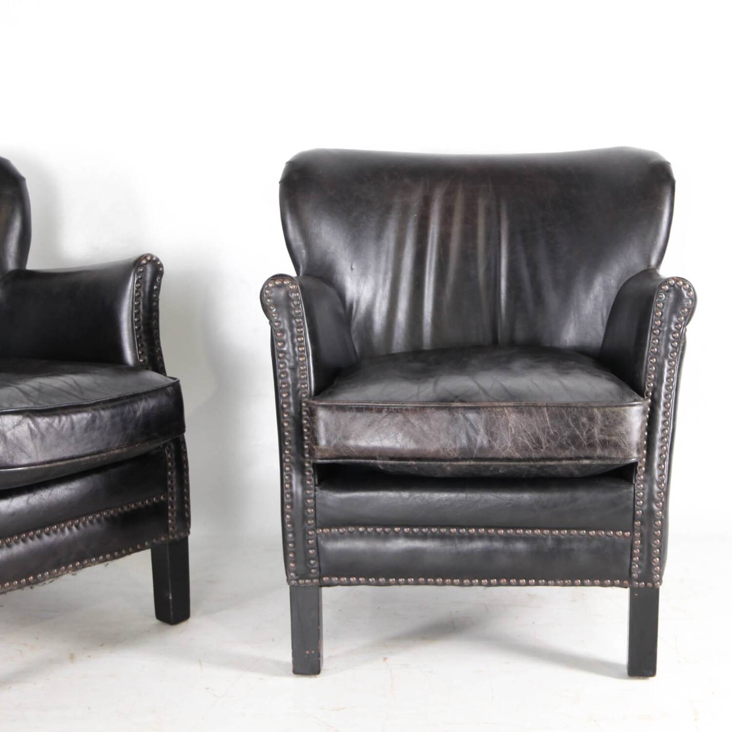 Pair of small leather club armchairs