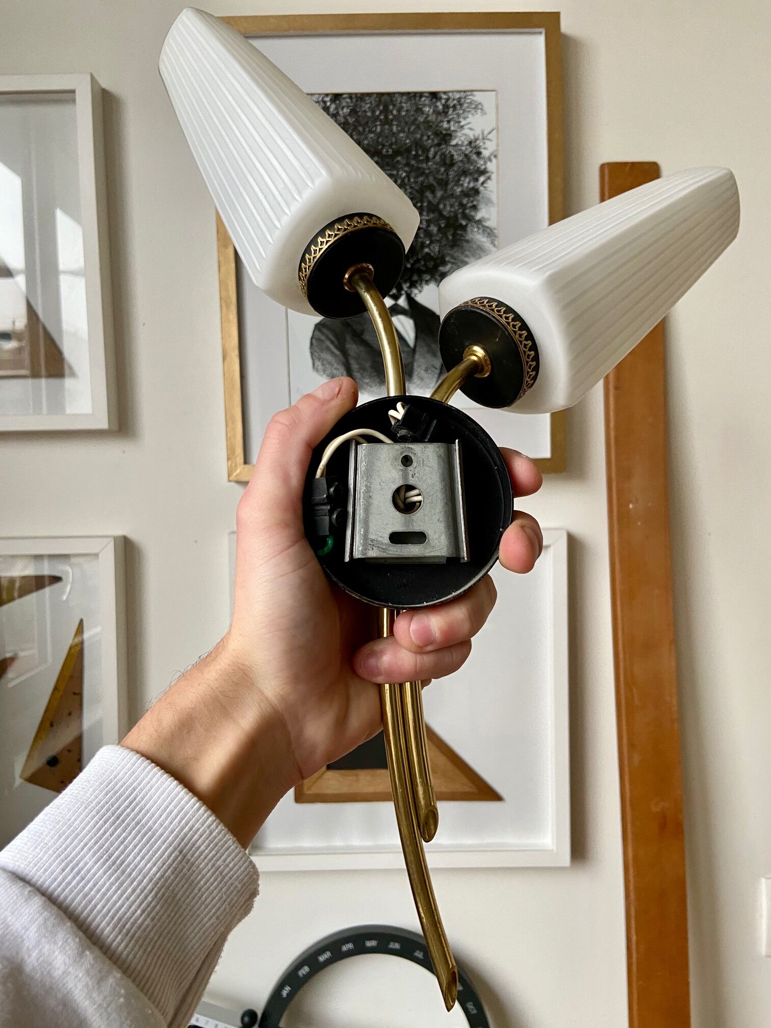 Black and gold metal wall and white opalines sconce