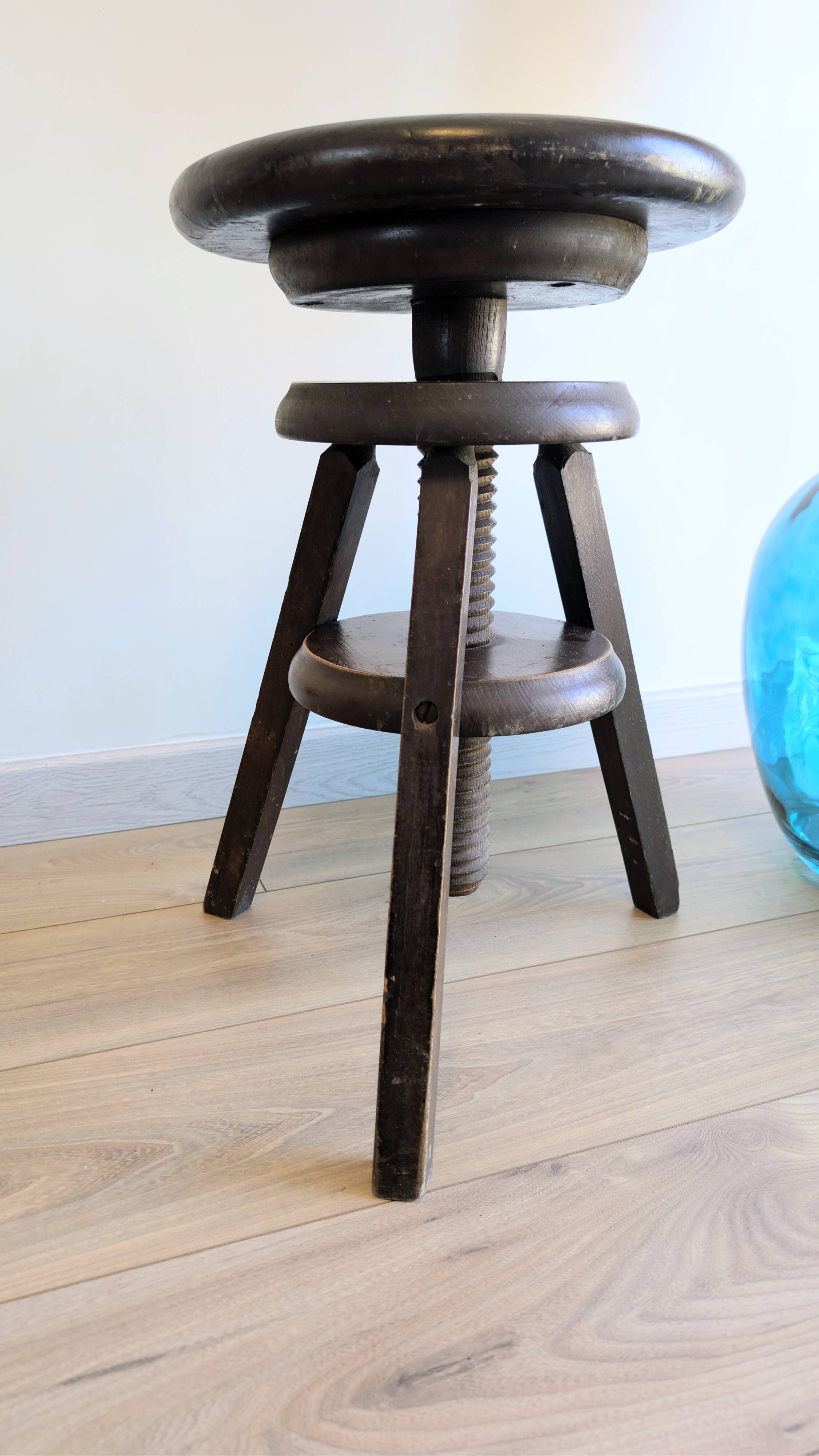 Antique wooden watchmaker's stool with screws, patinated wood.
