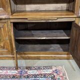 Library in walnut and oak from the early 20th century with its central clock.