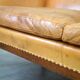 Unique old set of 2 club armchairs and a couch in cognac-colored leather with wheels