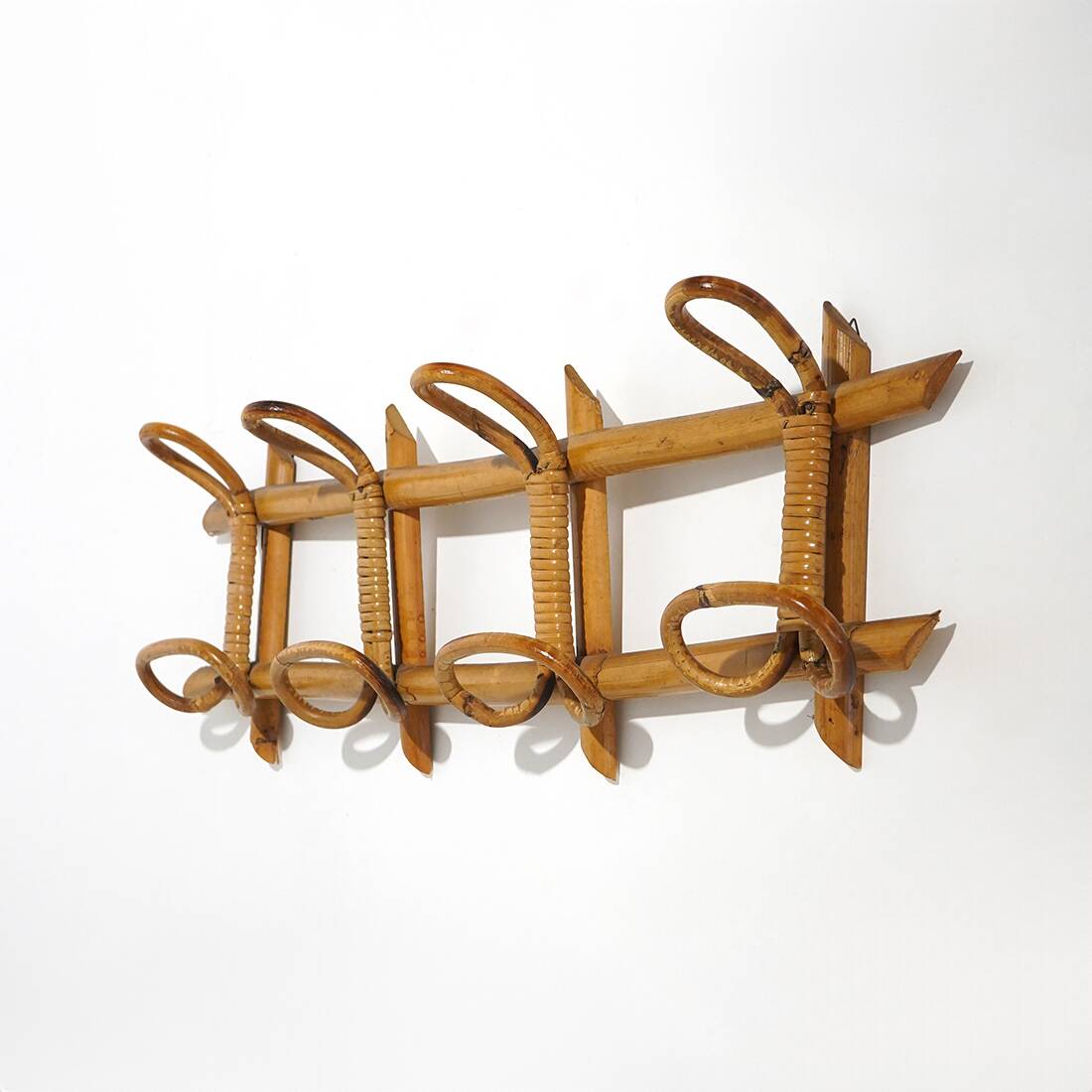 Wall coat rack in rattan and woven wicker, 1960s.