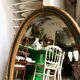 Oval mirror in wood and green and gold stucco, 75 x 42 cm