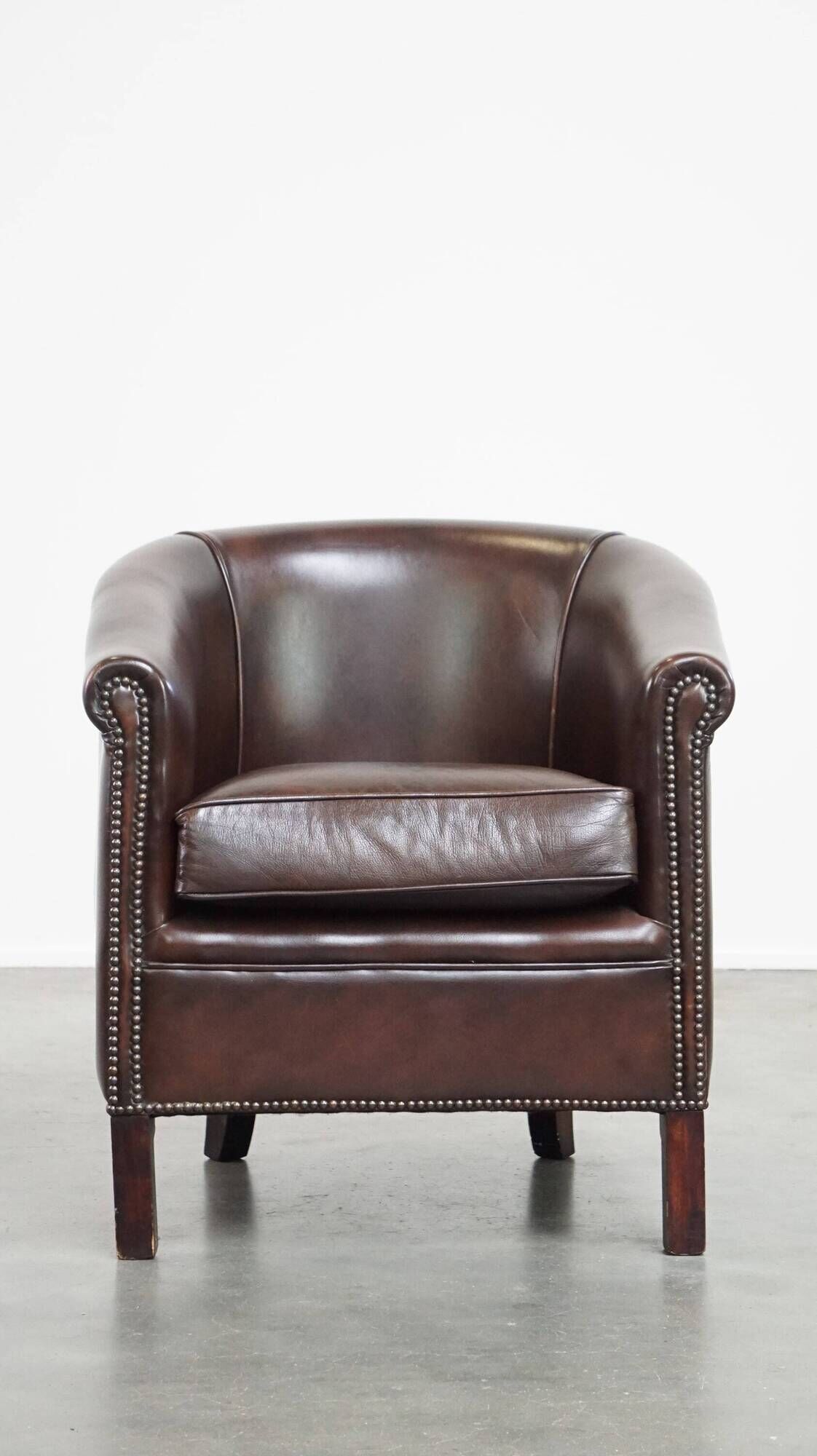 dark cowhide club chair in English style
