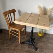 Bistro table with a central cast iron base in industrial style.