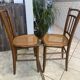 Pair of antique caned and wooden chairs from the 1900s.