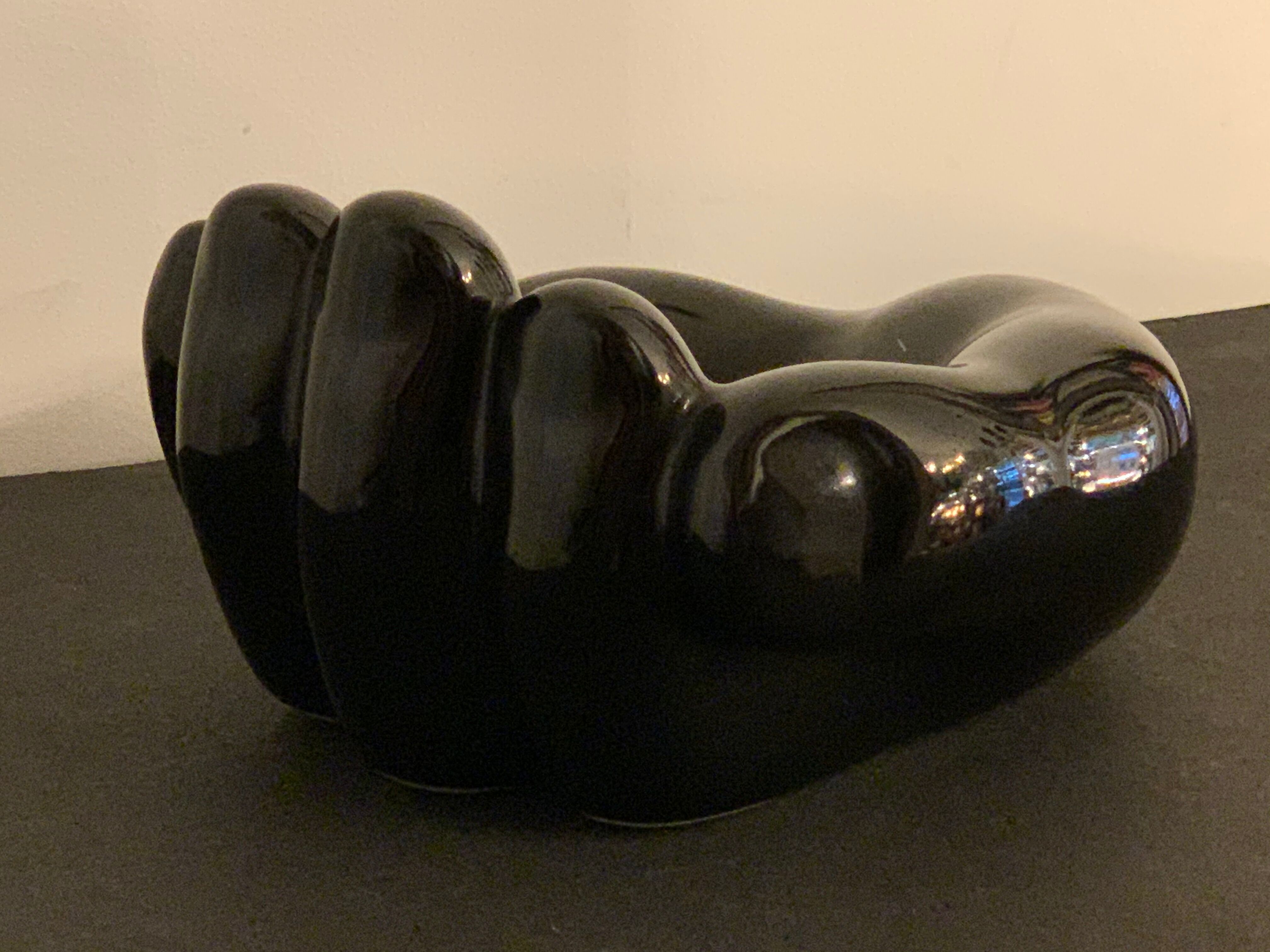 Black ceramic ashtray left hand