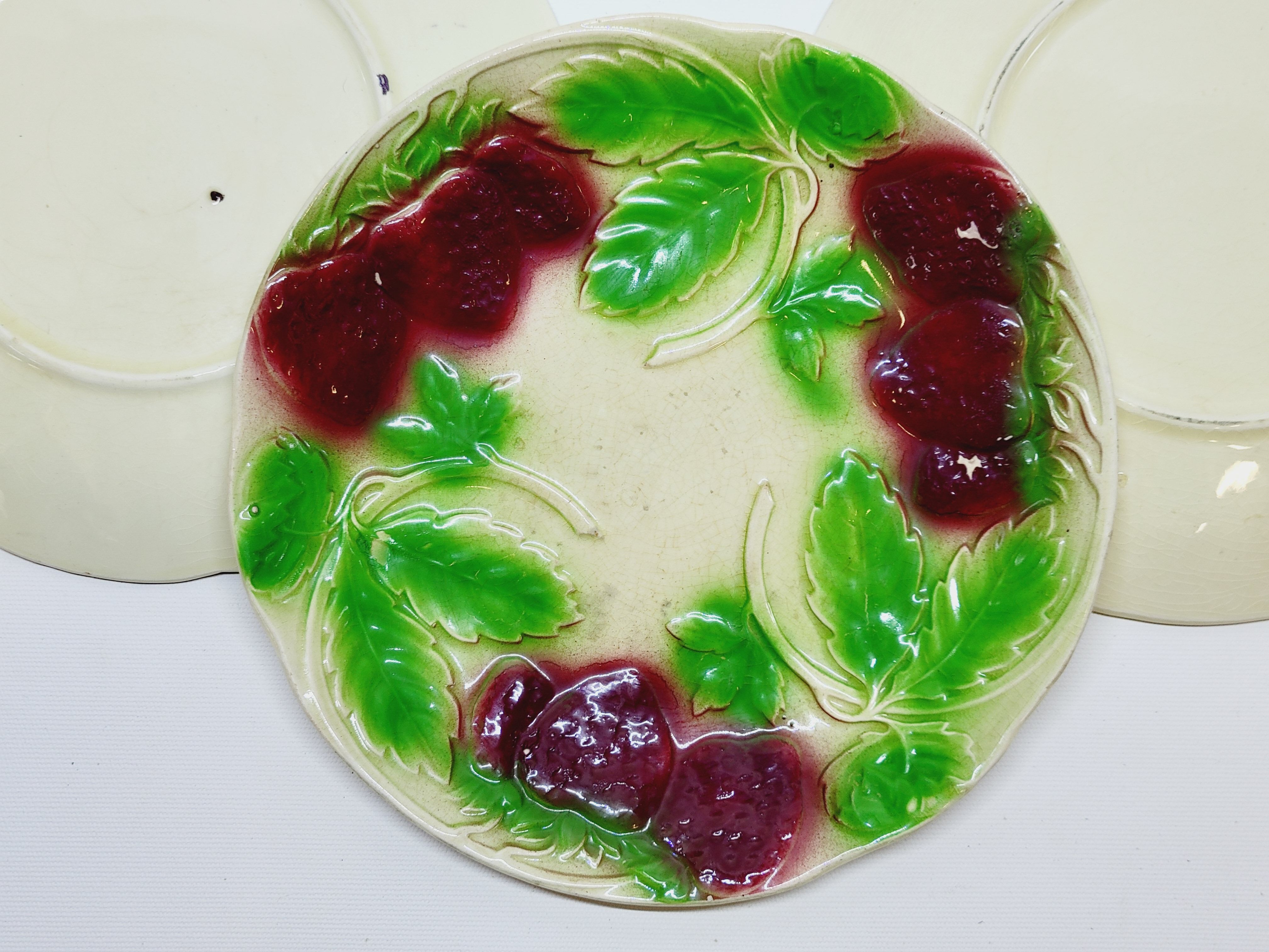 3 old plates in slip decoration strawberries and grapes