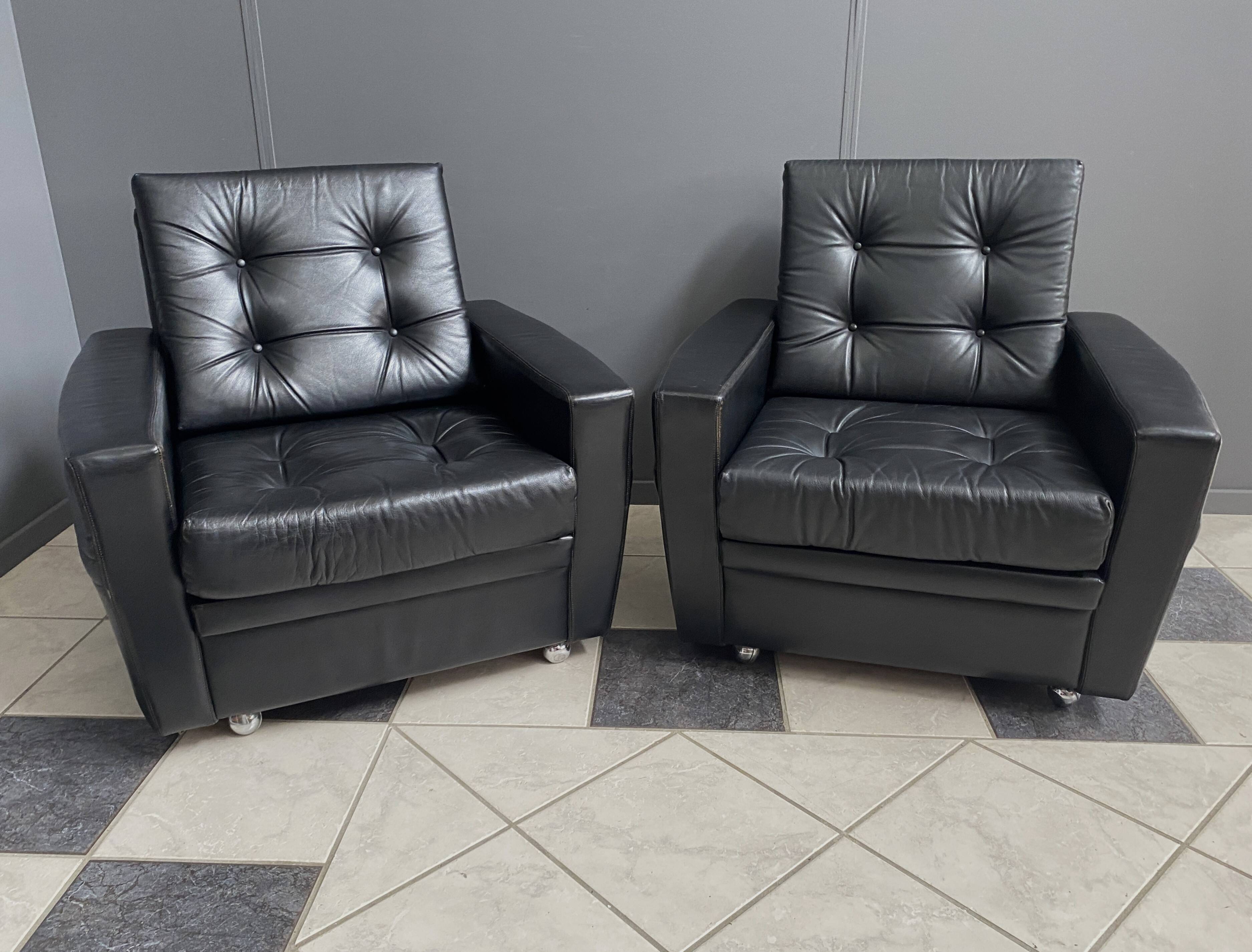 2 Black leather arm chairs 1960s on wheels