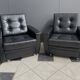 2 Black leather arm chairs 1960s on wheels