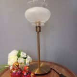 Table lamp with gold metal base and vintage white glass lampshade