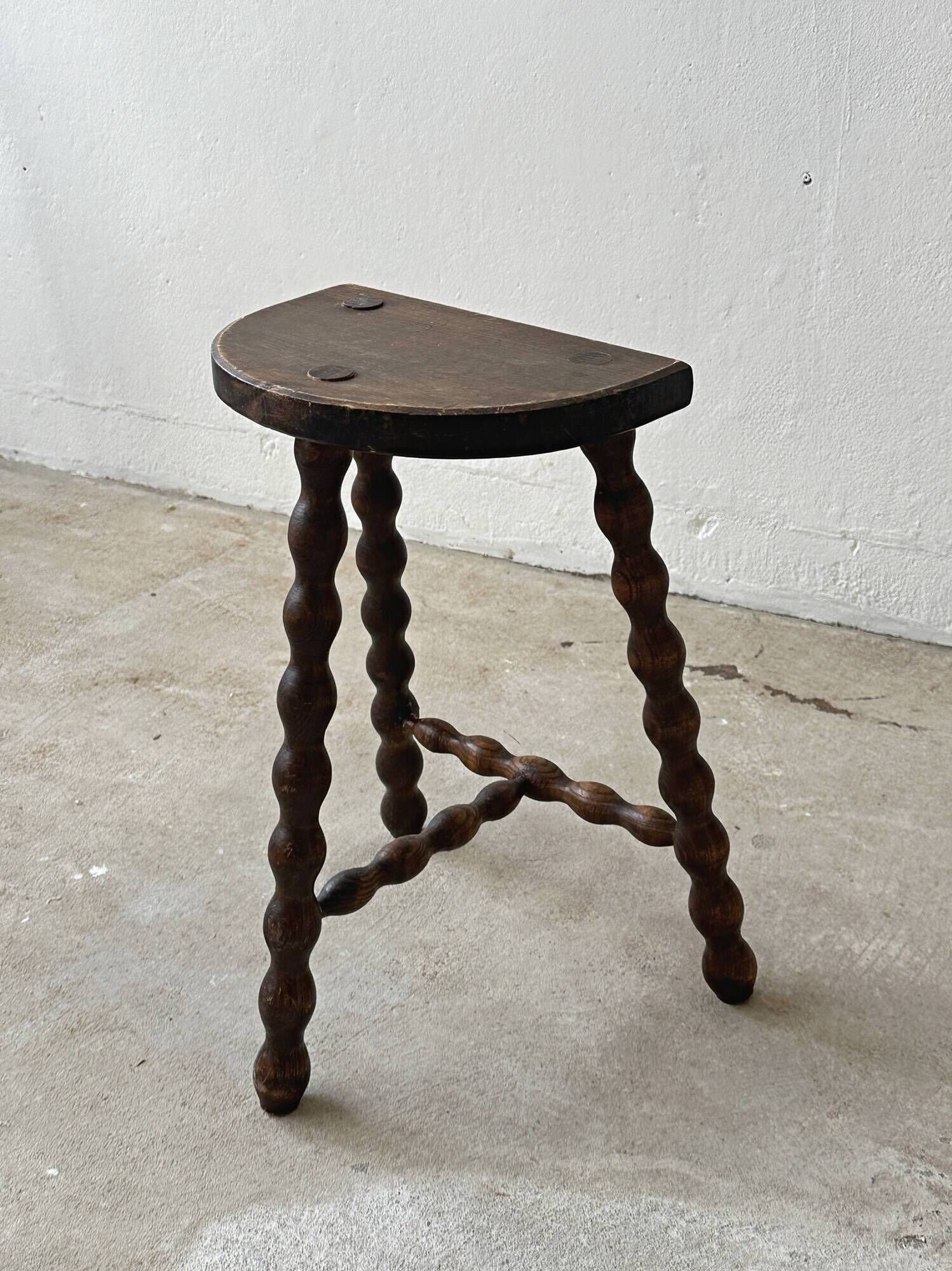 Two French farmhouse stools made of turned wood.