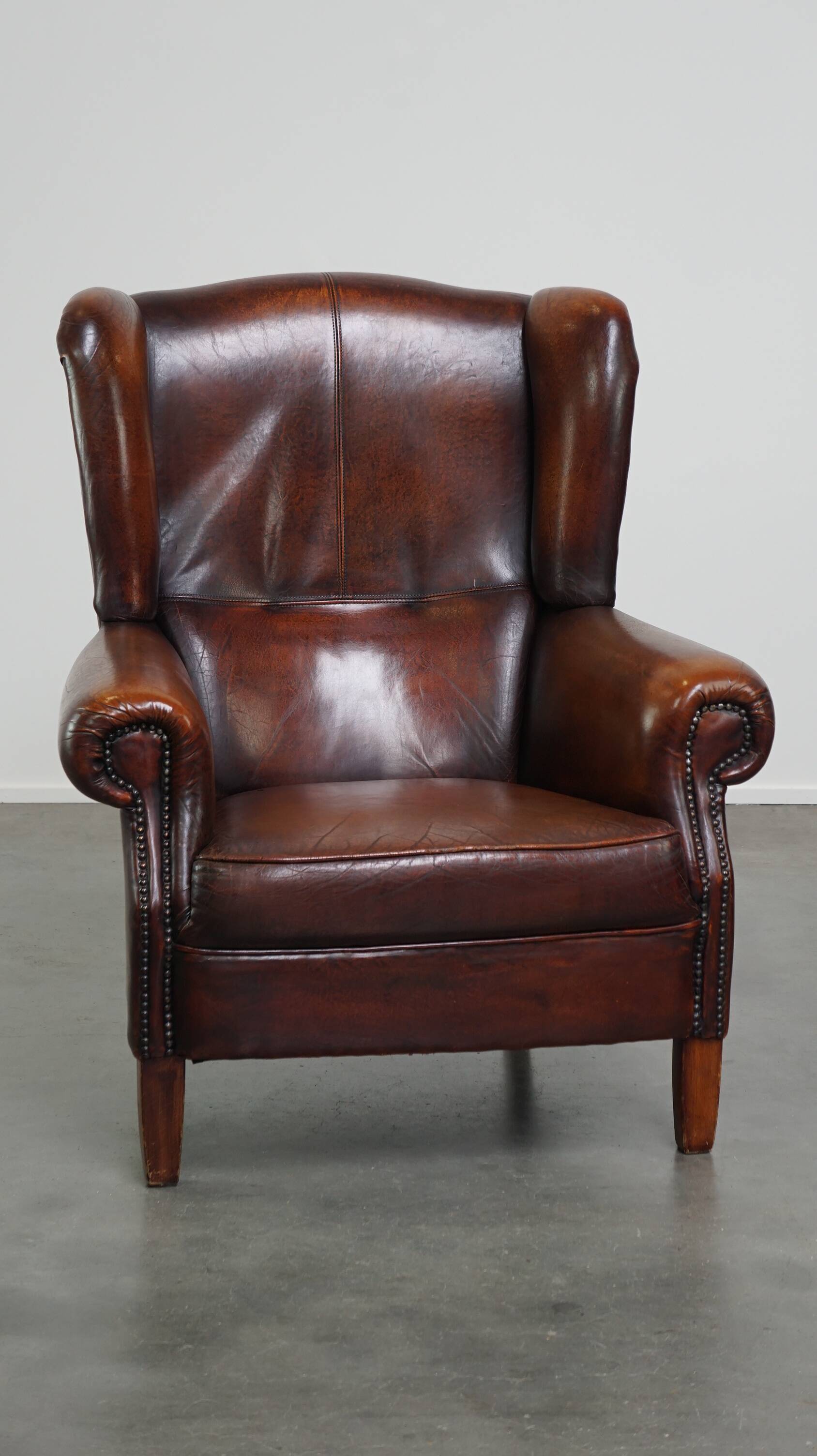 Luxurious sheepskin armchair with a fixed seat cushion and high seating comfort