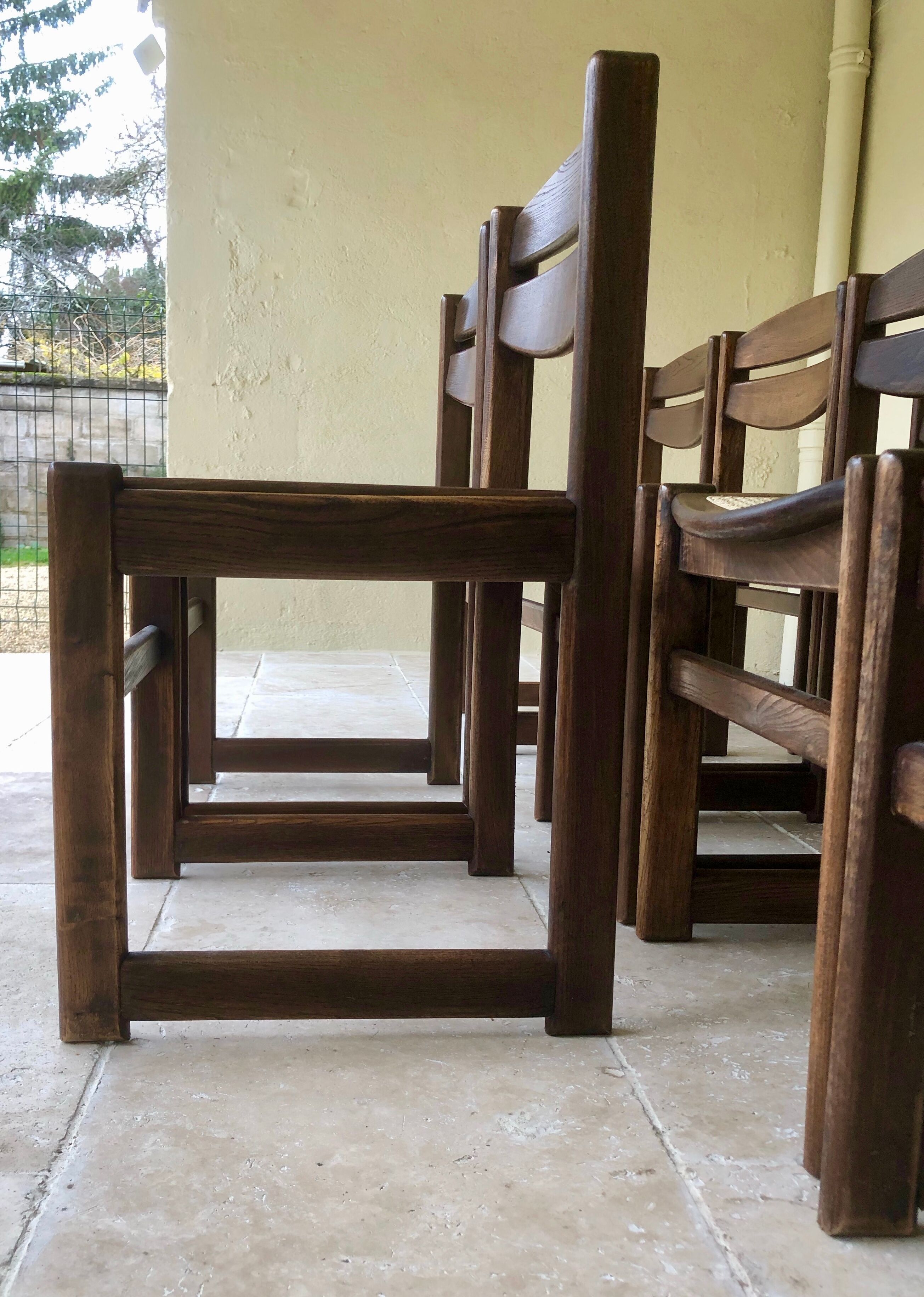 Set of 12 "sledge" dining chairs in walnut and cane.