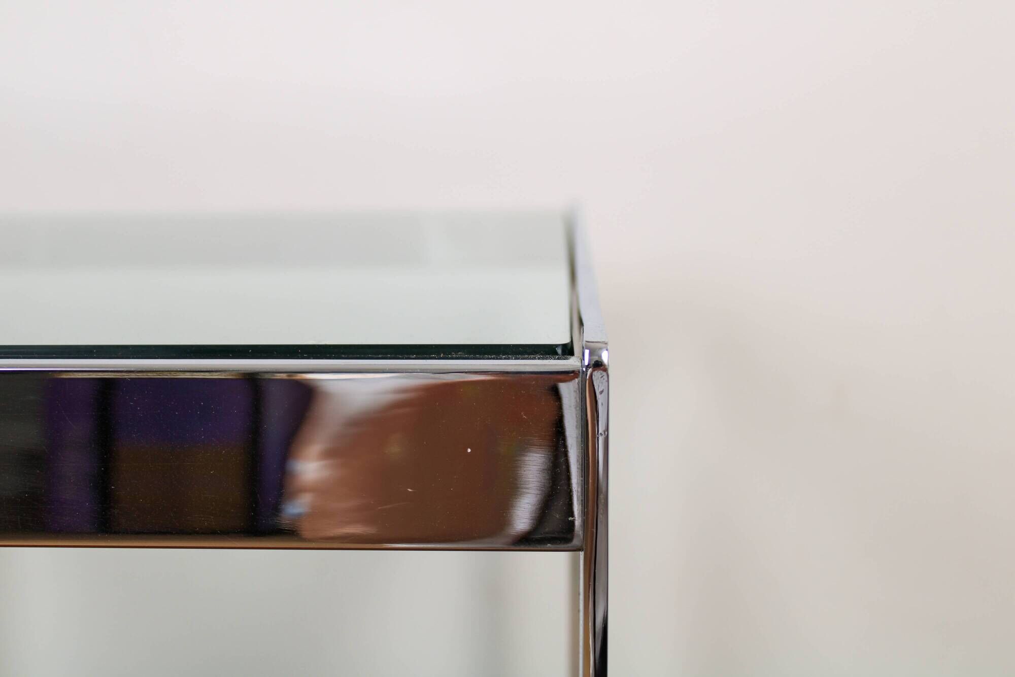 A vintage mid-century glass and rosewood side table by Merrow Associates