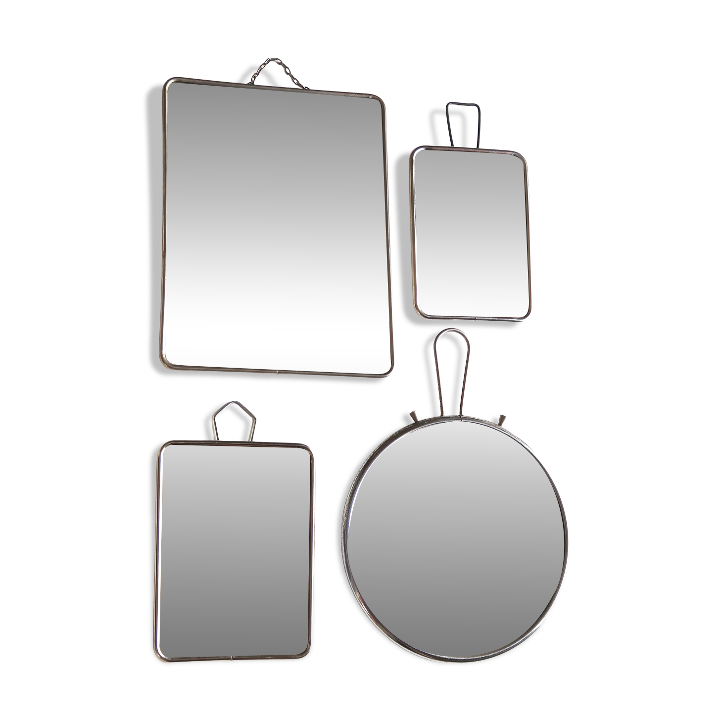 Set of four rectangular and round barber mirrors, 1950s.